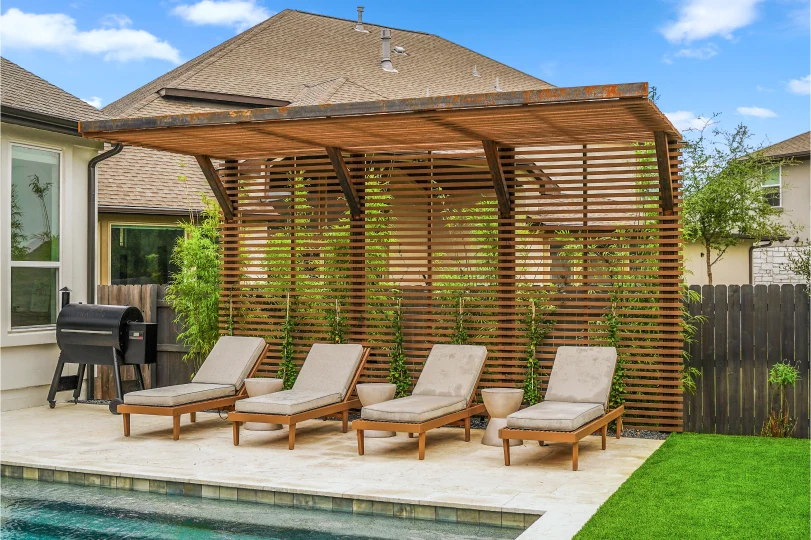 Cutters-Lake Pointe lounge chairs in front of wooden pergola