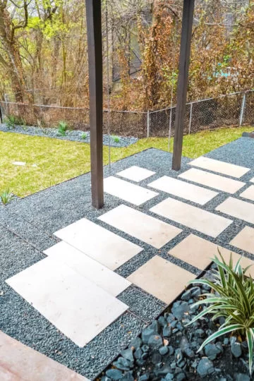 Lightly-colored rectangular pavers lined with grey pebbles.