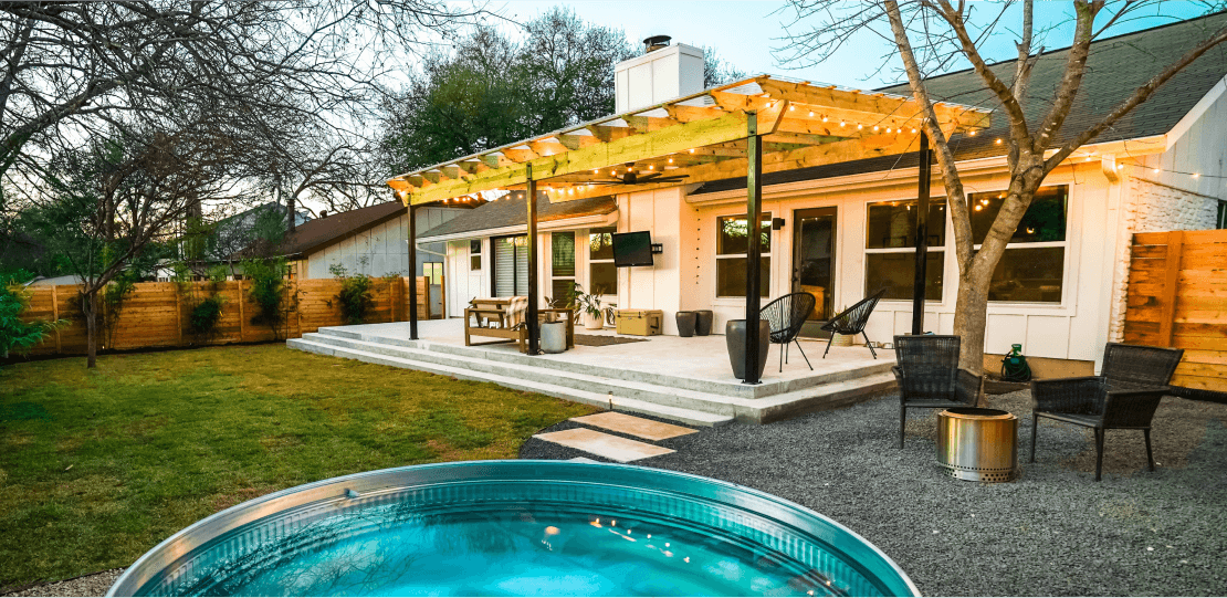 A backyard with a small, above-ground pool, and a patio covered with a wooden pergola.