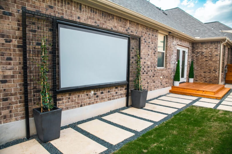 Close up of the projector screen with trellises on either side.