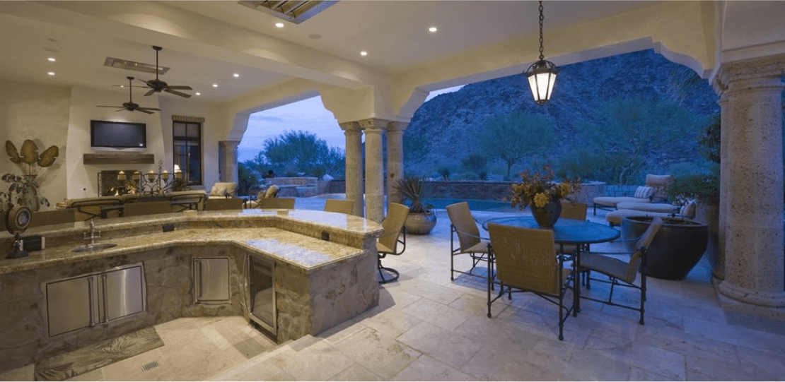 Cutters-Outdoor Kitchens 4 An indoor-outdoor stone kitchen and living area.