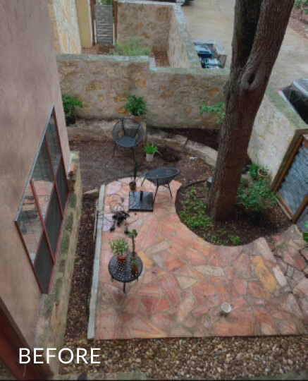 Aerial view of a small backyard surrounded by a light stone wall. Inside the yard, there's a large flat patch of red stones with metal chairs and tables on it. The word 'before' is overlaid atop the photo.