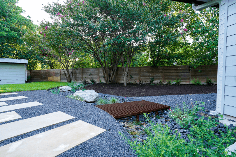 Landscaped backyard with black gravel