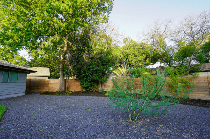 Black gravel in a landscaped backyard