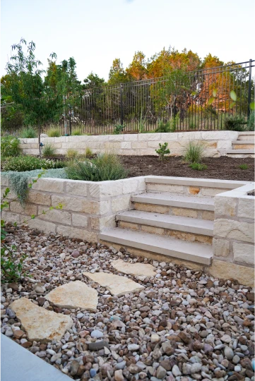 Cutters-trails of dripping springs white stone steps in flower bed