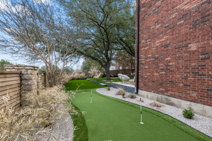 Artificial turf putting green in the side yard of a home in Round Rock.
