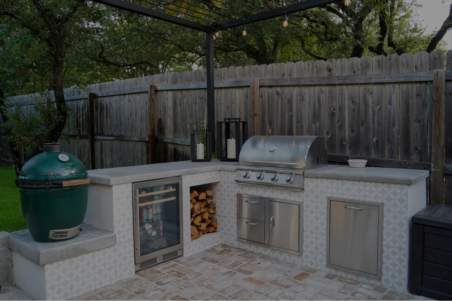 An outdoor galley kitchen with a stove, oven, sink, and open counter space.